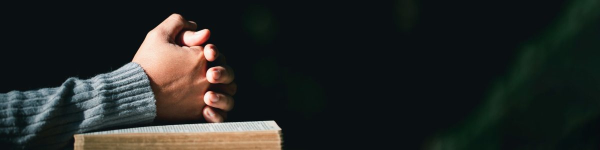 Prayer person hand in black background. Christian catholic woman are praying to god in dark at church. Girl believe and faith in jesus christ. Christ religion and christianity worship or pray concept.